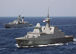 A Singaporean ship sailing in front of an Indian ship in the Bay of Bengal